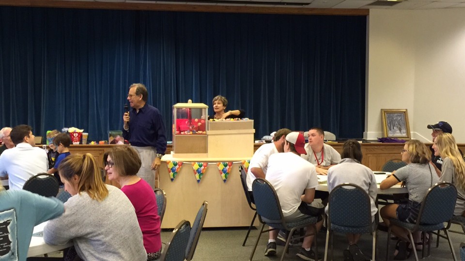 A group of people sitting at tables.