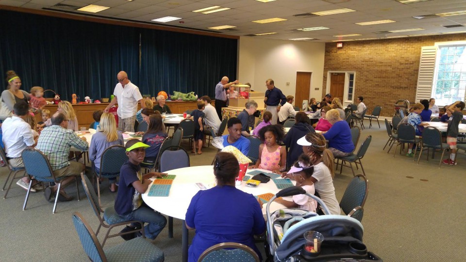 A group of people sitting at tables in a room.