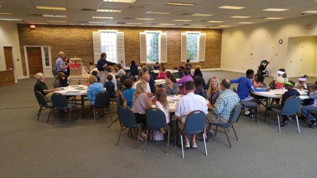 A group of people sitting at tables in a room.