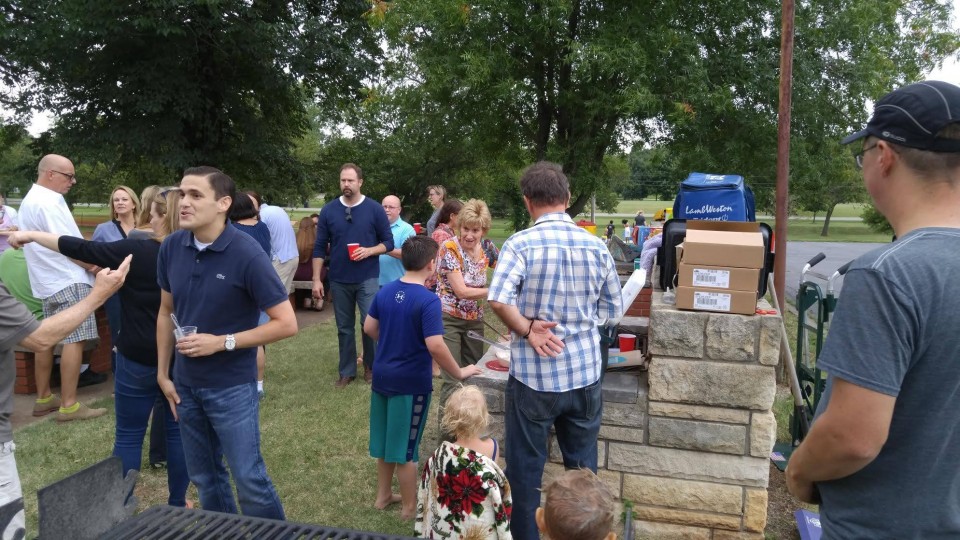 A group of people gathered around a grill.