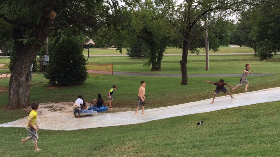 A group of people playing in a park.