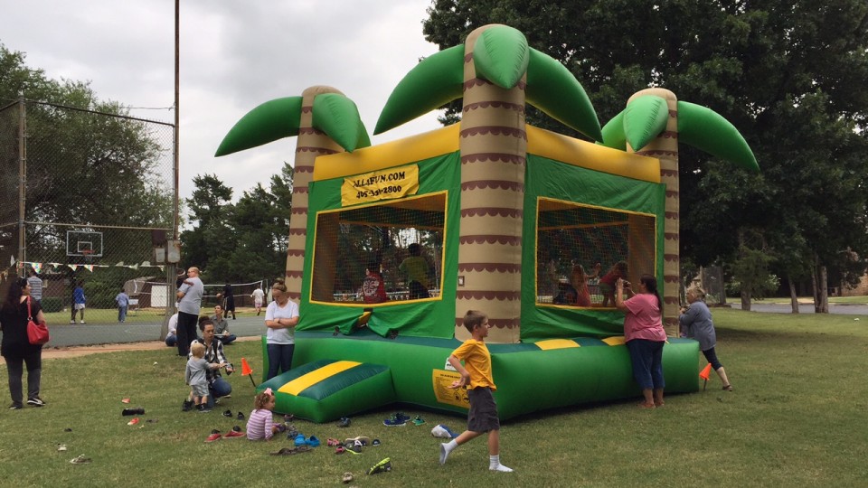 A group of children playing in an inflatable bounce house.