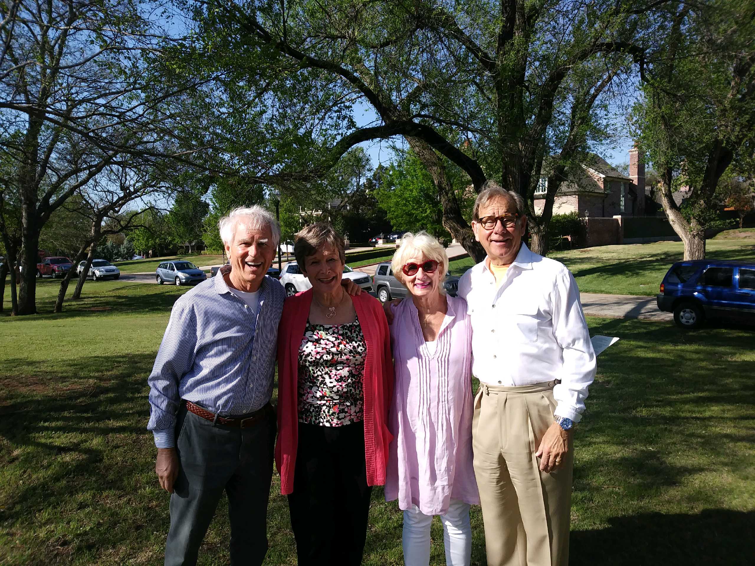 A group of people posing for a picture in a park.