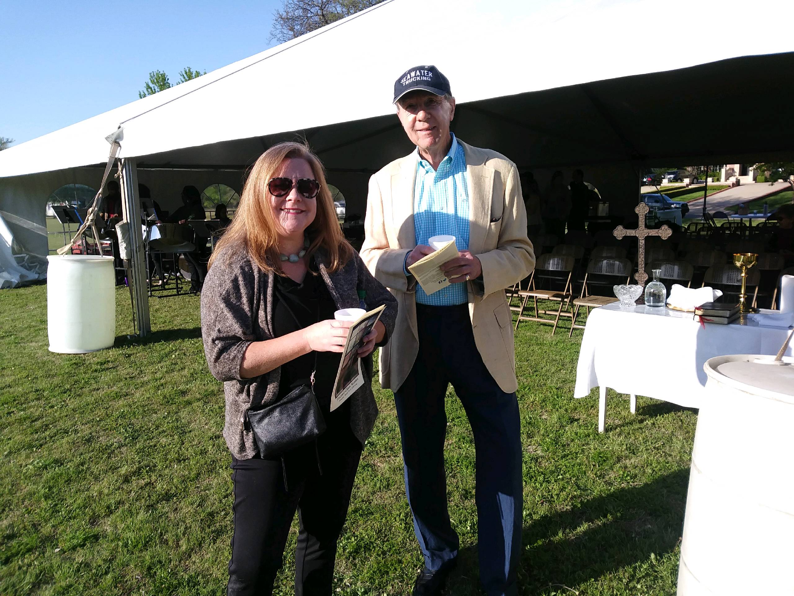 A man and a woman standing next to a tent.