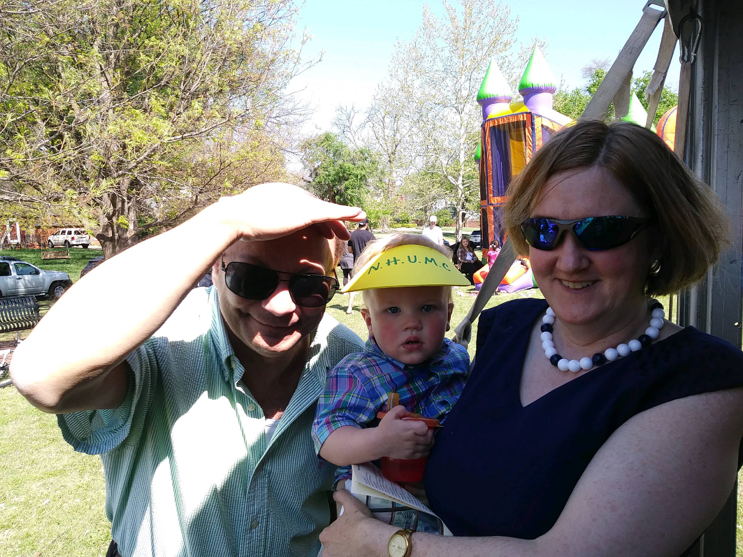 A woman wearing a blue shirt and a man wearing a hat.