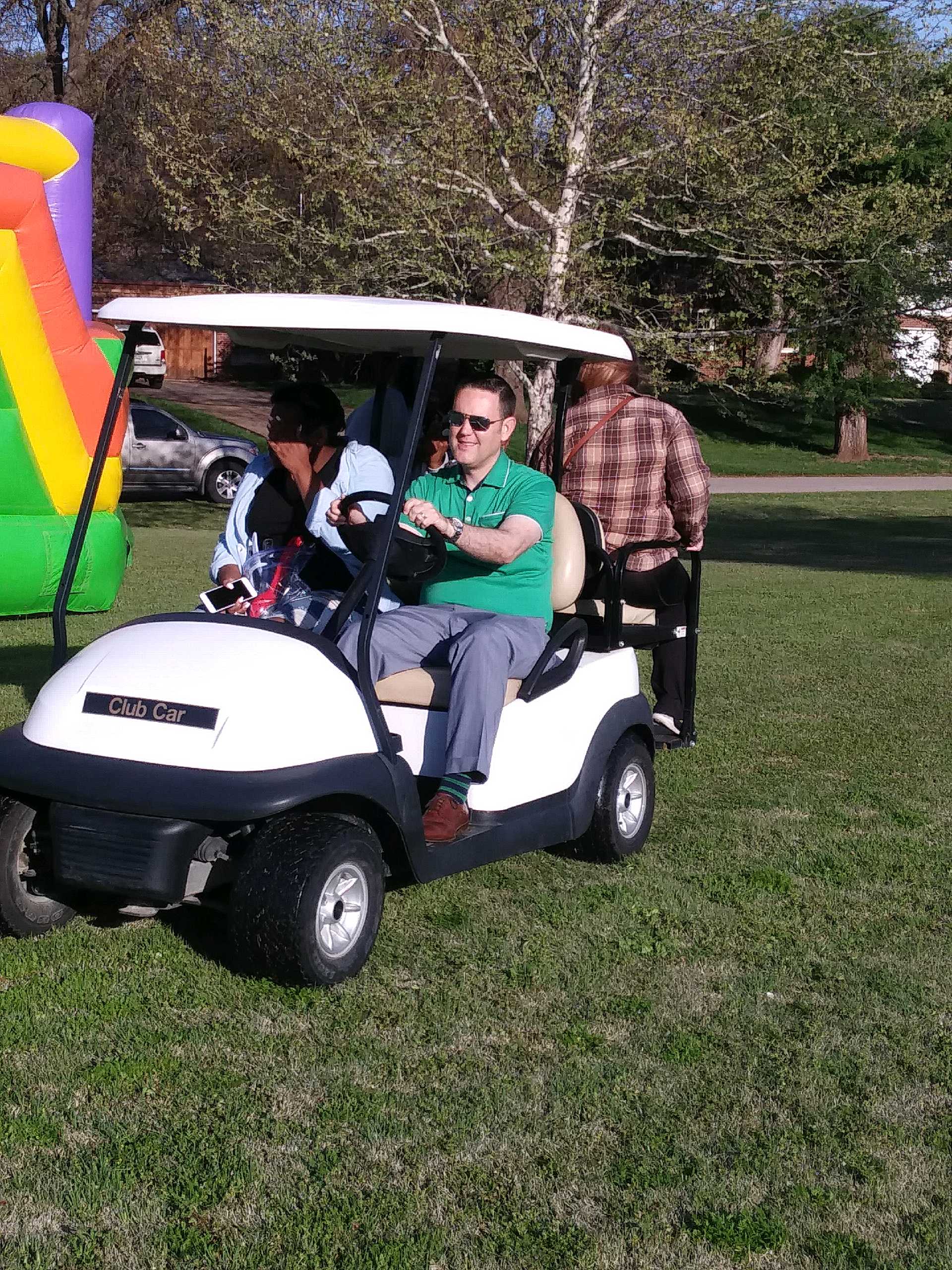 A group of people riding in a golf cart.
