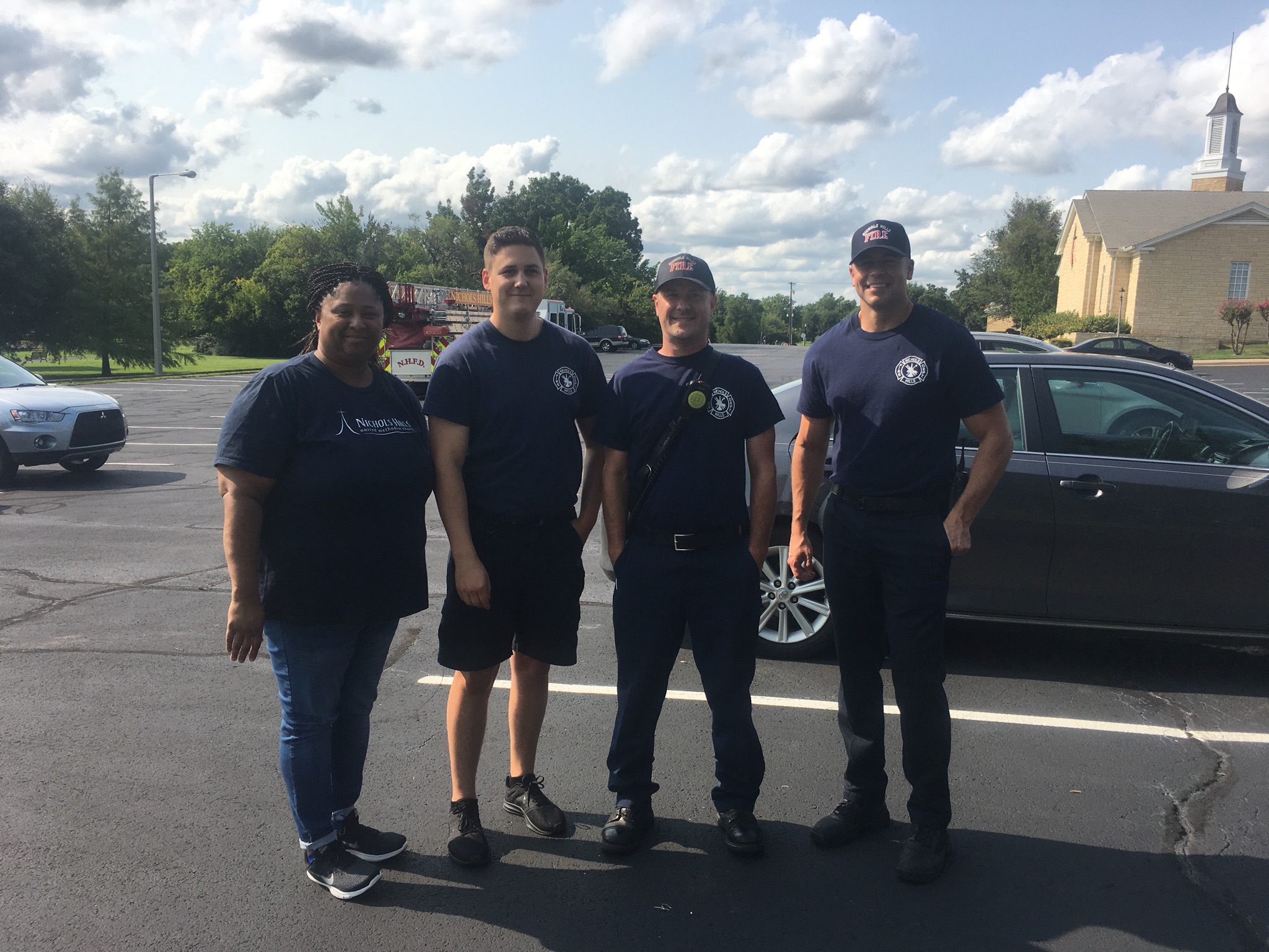 A group of people standing in a parking lot.