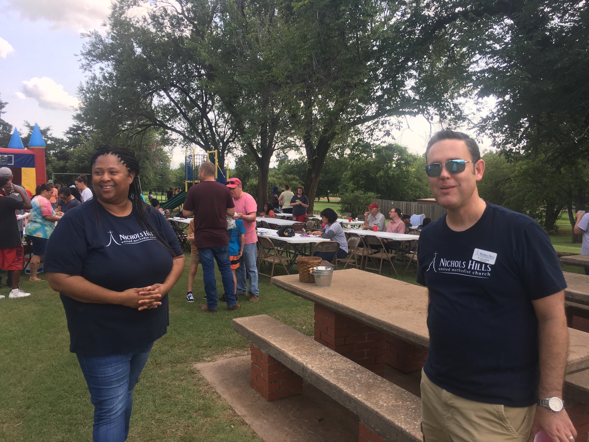Two people standing in a park.