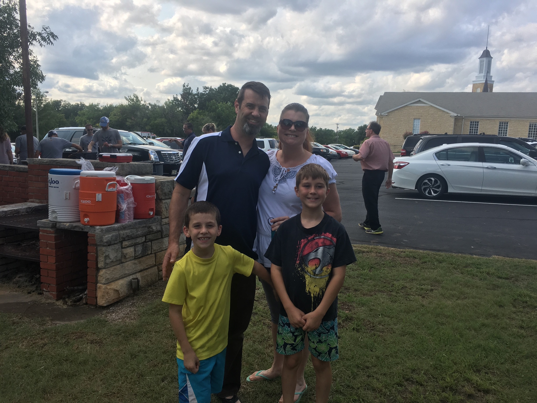 A group of people standing in a parking lot.