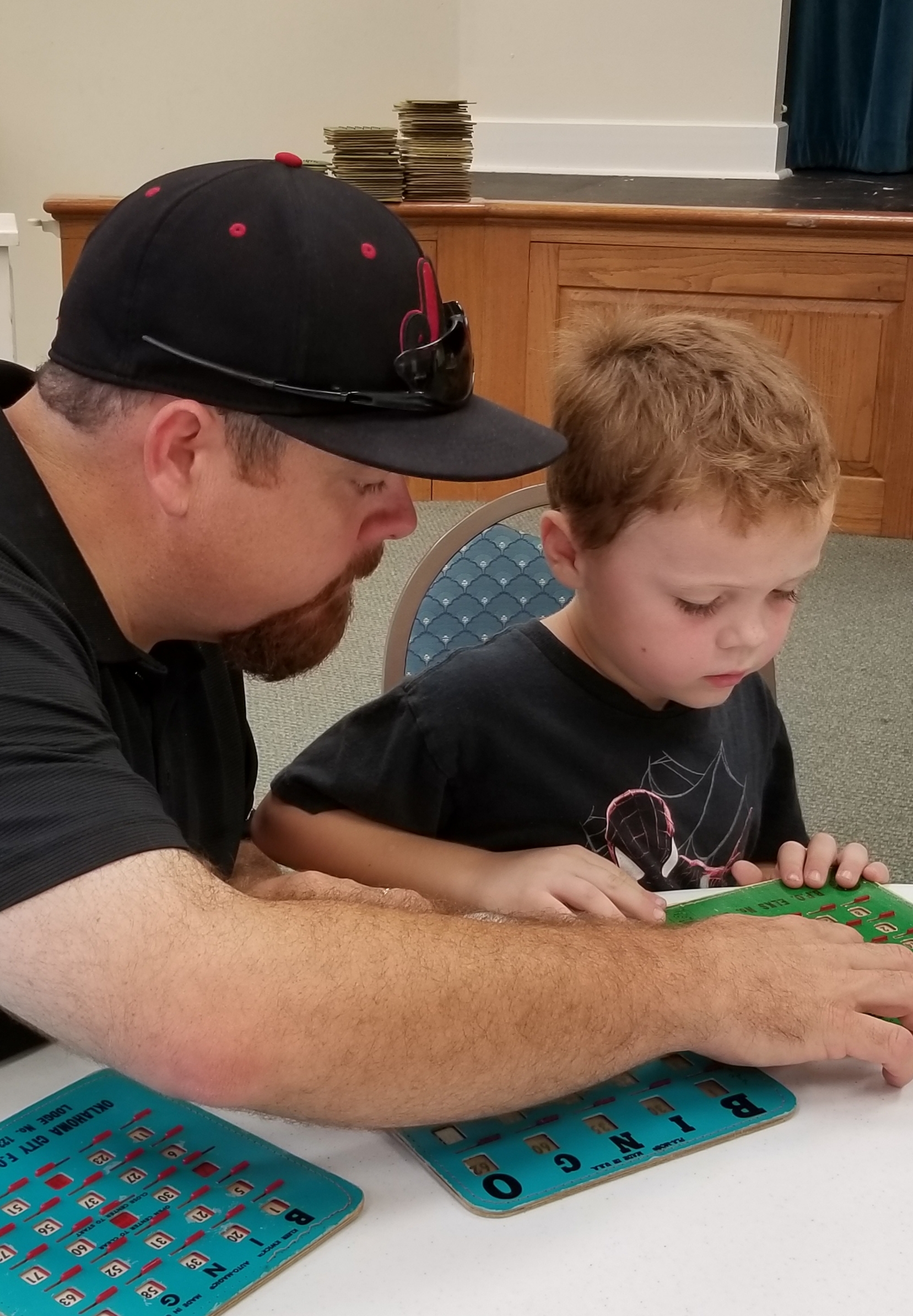 A man and a young boy playing a game of tic-tac-toe.