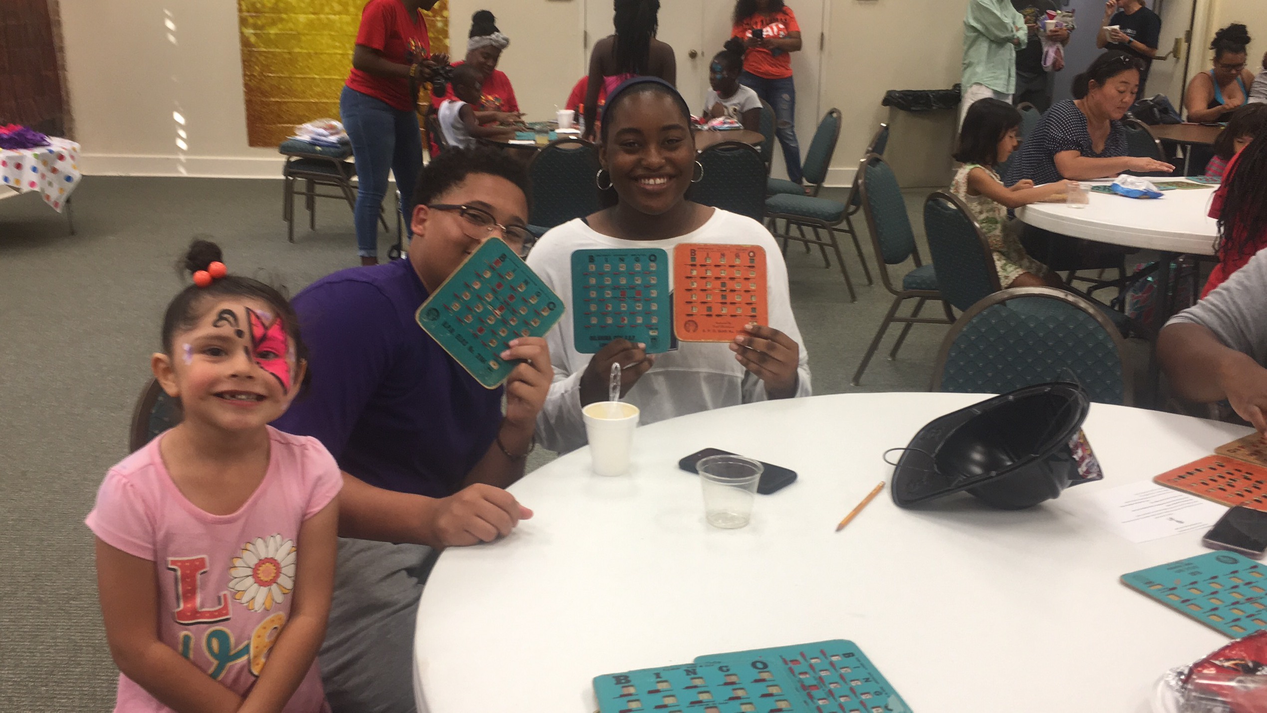 A group of people sitting at a table with a group of children.