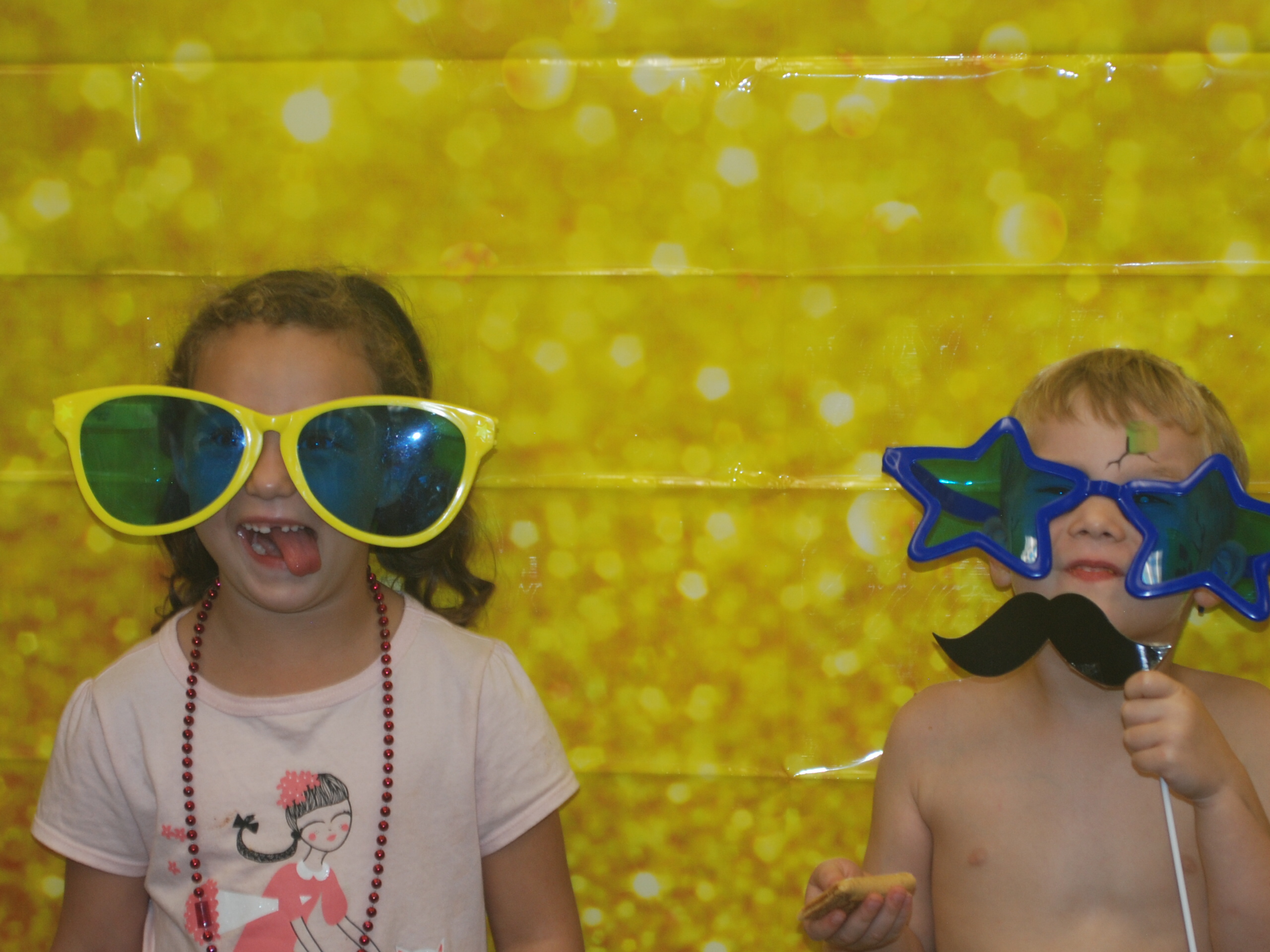 Two children wearing sunglasses.