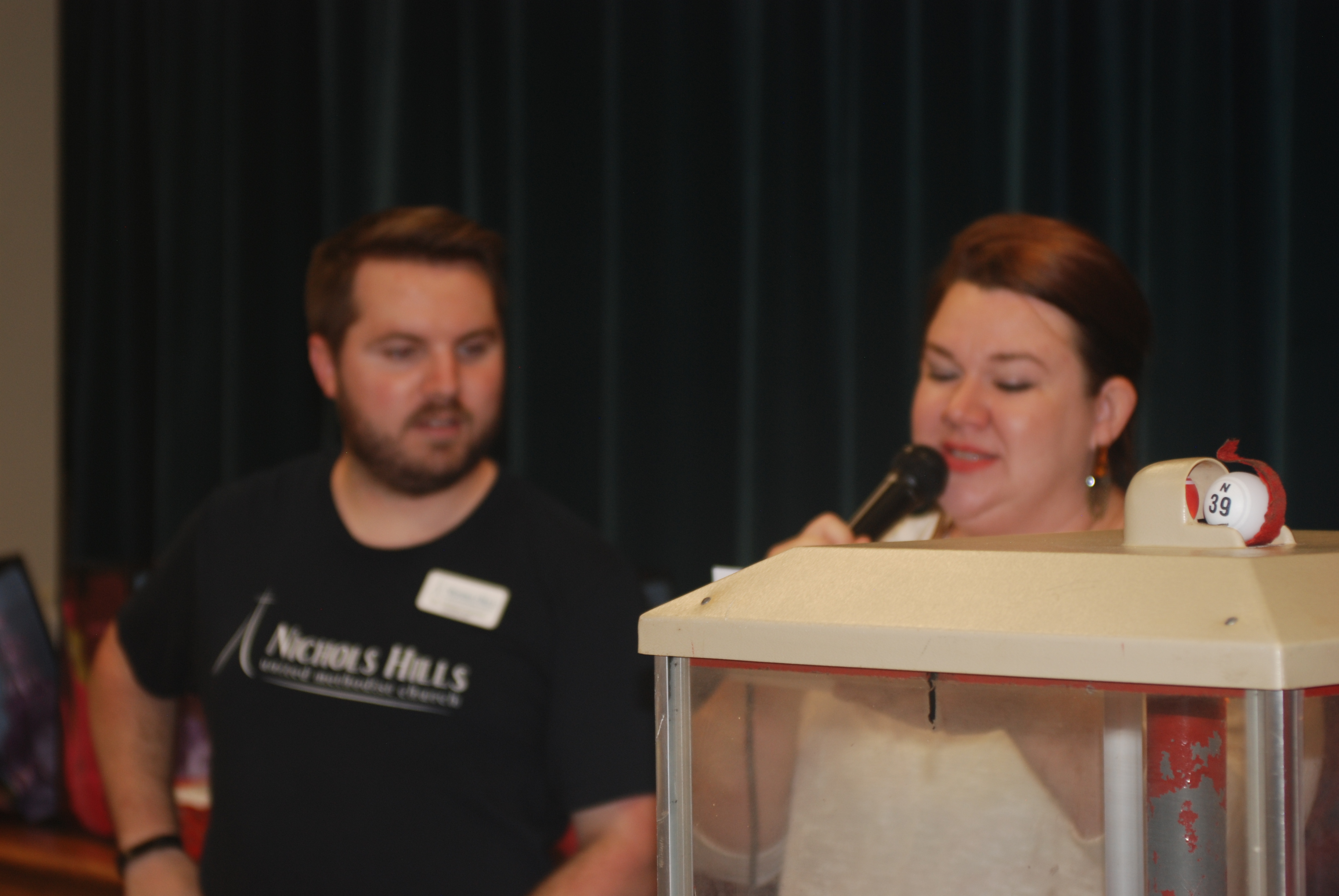 A man and a woman standing next to a box.