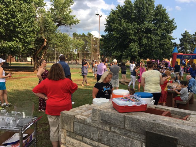 A group of people standing in a park.