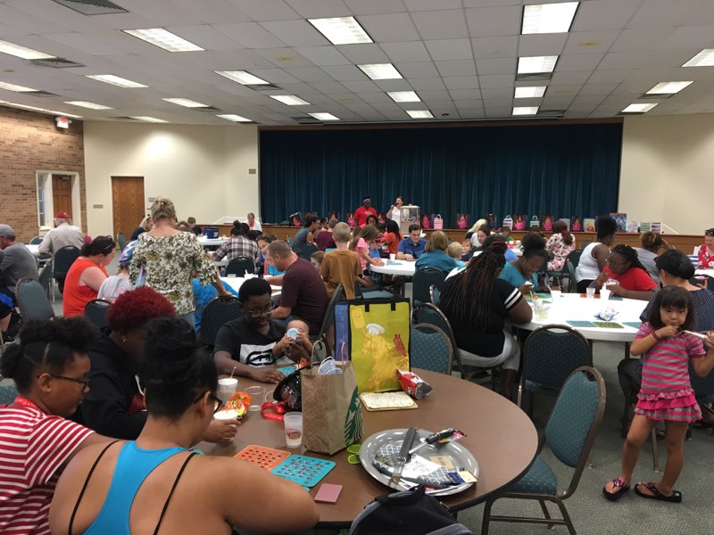 A group of people sitting at tables in a room.
